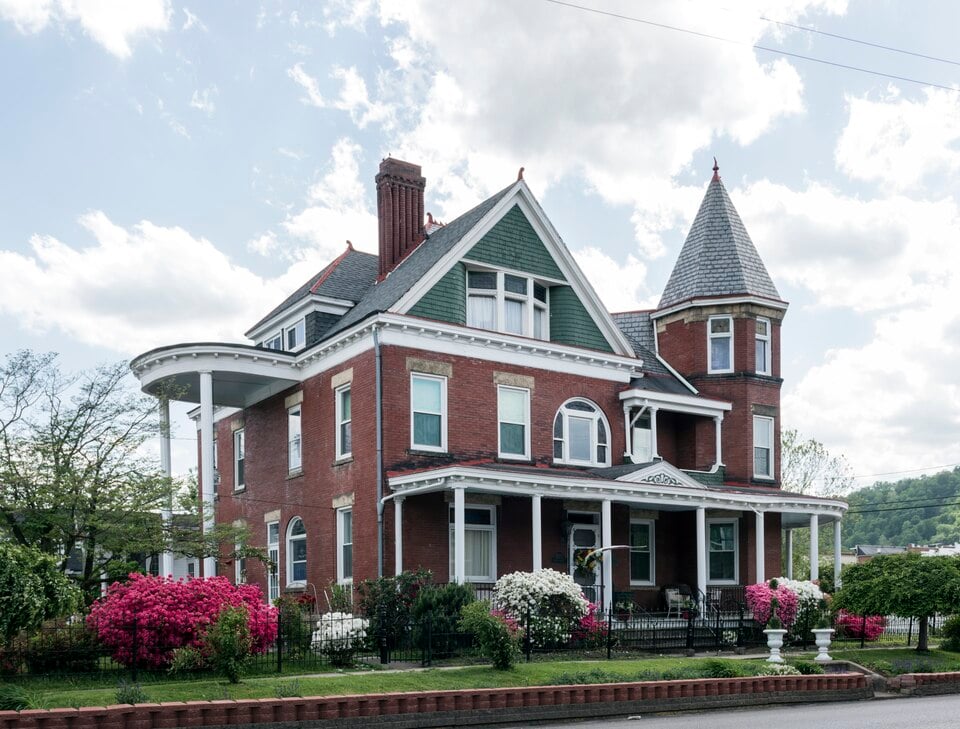 Victorian mansion with ornate porch in Louisville Kentucky representing the Gilded Age architecture of Old Louisville