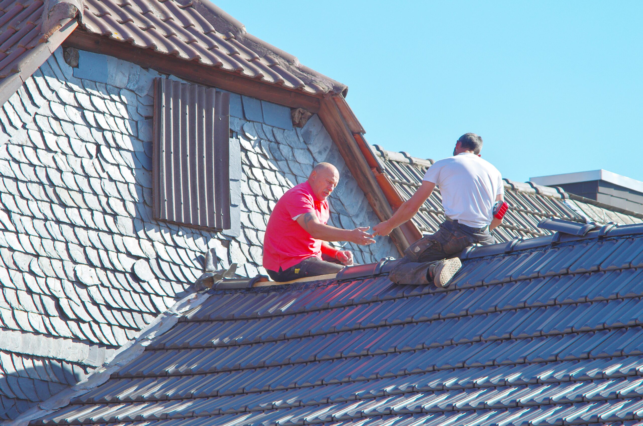 A roofing crew performing a residential roof replacement in Louisville Kentucky following Kentucky building code compliance standards