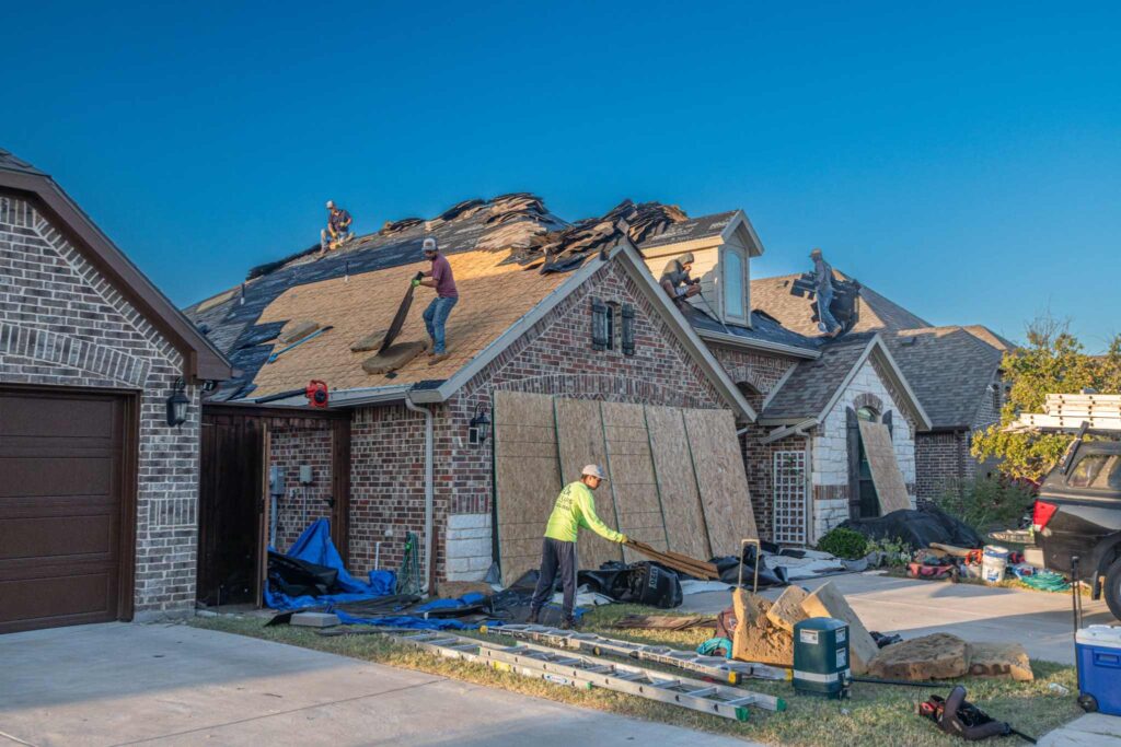 A professional roofing contractor assessing storm damage on a residential roof